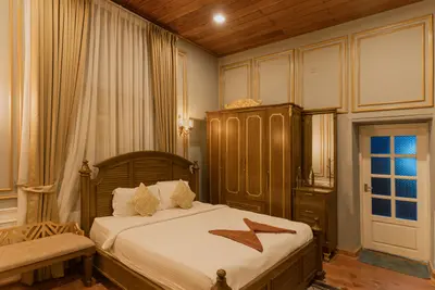 Traditional wooden furniture and colonial decor inside british bungalow wayanad rooms